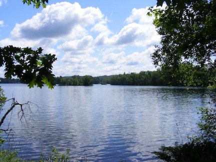 We are standing in bright sunshine. The blue
                  lake and blue sky can be seen behind us.