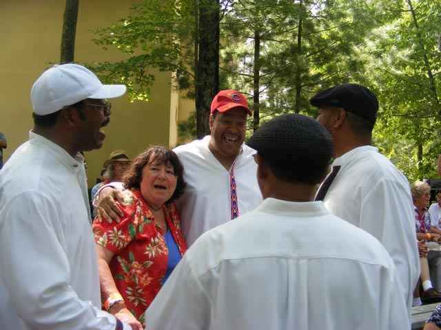 Lolly Bower surrounded by the        guys from 100% Natural